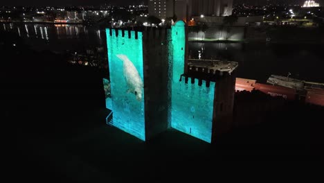 Audiovisual-projection-multimedia-light-show-against-Ozama-Fortress,-aerial