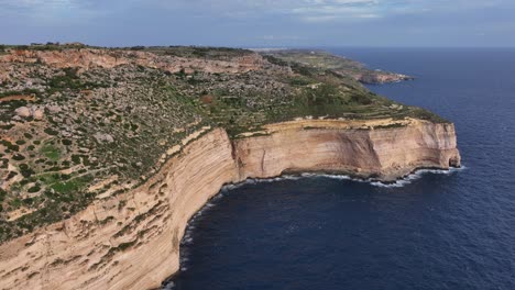 Aerial-drone-shot-of-steep-cliff-over-the-Mediterranean-sea-from-the-Dingli-Cliffs-in-Malta