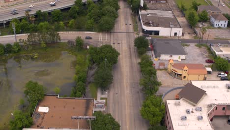 Drone-shot-reveal-Downtown-Houston,-Texas-and-59-South-freeway