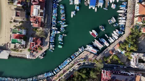 Drone-eye-view-of-a-marina-showcasing-boats-and-yachts-in-Huatulco,-Oaxaca,-Mexican-Pacific