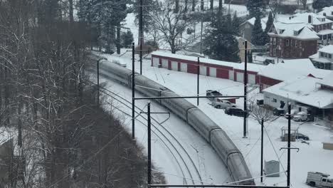 Amtrak-train-on-snow-covered-tracking-in-winter-in-Pennsylvania