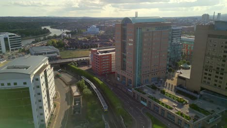 Aerial-shot-of-a-train-passing-through-Belfast-City-Centre-on-a-sunny-day