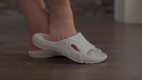 Slow-motion-shot-of-a-woman-removing-her-rubber-shoes-ready-for-a-massage