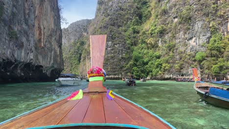 Long-tail-boat-entering-Pileh-lagoon-in-Phi-Phi-islands,-Thailand