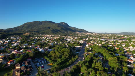 Aerial-establishing-shot-of-tropical-city-of-Puerto-Plata-at-sunset-time