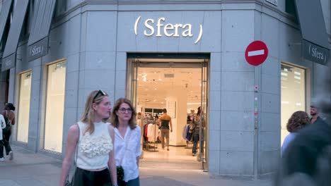 Pedestrians-and-shoppers-walk-past-the-Spanish-clothing-manufacturing-and-brand-Sfera-store