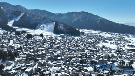 Drone-pull-away-shot-of-Japans-Nozawaonsen-Mountain-Ski-Resort-Village