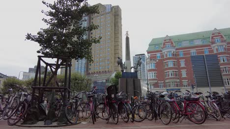 Bicycles-Parked-Next-To-Trinity-Sculpture-At-Triangeln-In-Malmo,-Sweden