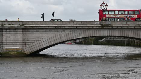 Double-Decker-London-Bus-Driving-Over-Putney-Bridge,-United-Kingdom