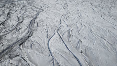 An-aerial-perspective-of-a-frozen-river-near-Seljalandsfoss-in-southern-Iceland