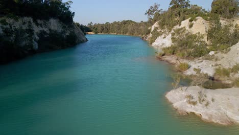 Aerial-profile-view-of-clear-water-of-little-blue-lake-in-Tasmania,-Australia-during-daytime