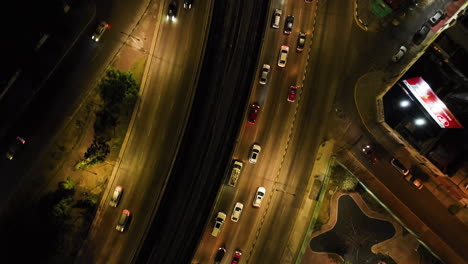 Aerial-tilt-shot-over-traffic-on-the-Circuito-Interior-Avenue,-night-in-Mexico-City