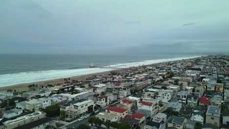 Panoramic-waterfront-cityscape,-manhattan-beach-sea-waves-houses-neighborhood-in-oceanfront-low-key-south-bay-community