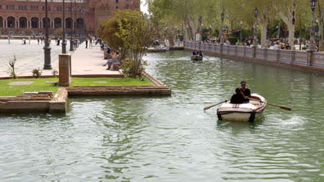 Plaza-de-Espana-River-Boat-Ride-In-The-Parque-de-María-Luisa-In-Seville,-Spain