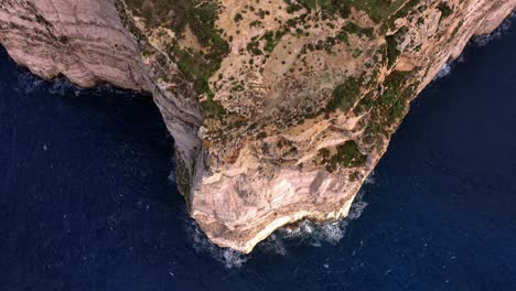 Aerial-drone-shot-of-steep-cliff-over-the-Mediterranean-sea-from-the-Dingli-Cliffs-in-Malta