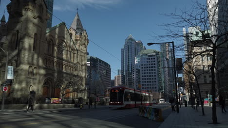 Wide-shot-of-King-Street-with-passing-streetcar-coming-to-a-stop-Wide-shot-of-streetcar-approaching-and-coming-to-a-stop-on-King-Street
