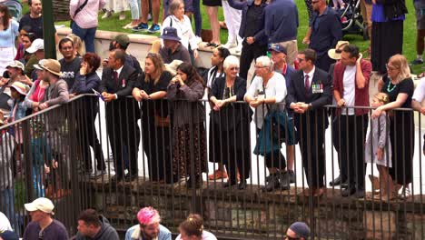 Large-crowds-of-people-lined-up-along-Adelaide-street,-watching-the-annual-parade-on-Anzac-Day-at-downtown-Brisbane-city,-close-up-shot