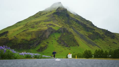 Skater-pushes-in-the-road-with-Icelandic-mountains-in-the-background