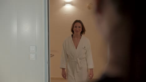 Slow-motion-shot-of-a-woman-walking-into-a-spa-room-ready-for-her-treatment