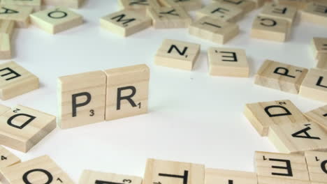 Scrabble-game-tile-letters-placed-on-edge-on-table-to-form-word-PRIDE