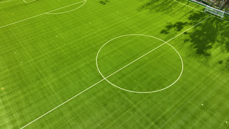 Aerial-flyover-empty-soccer-field-in-Poland-during-sunny-day