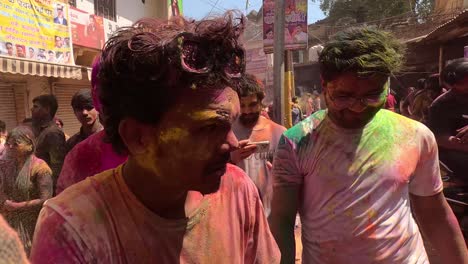 POV-SHOT-CAMERA-People-are-flying-colors-in-front-of-the-camera-and-people-are-walking-towards-the-temple-with-joy