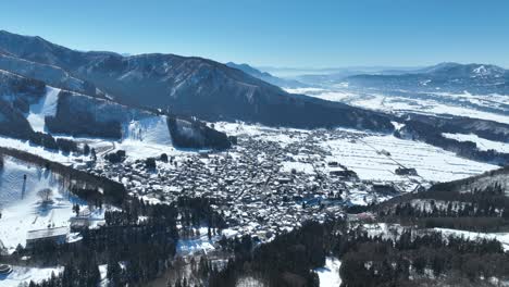 Aerial-establishing-pull-away-shot-of-Japans-Nozawaonsen-Mountain-Ski-Resort-Village