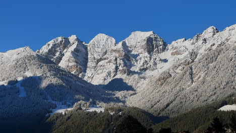 Early-November-first-snow-on-Europe-Australian-Swiss-Alps-peaks-fall-autumn-Stubai-Village-chalet-Tirol-Tyrol-Austria-frosted-morning-sunshine-Innsbruck-mountains-landscape-static-shot