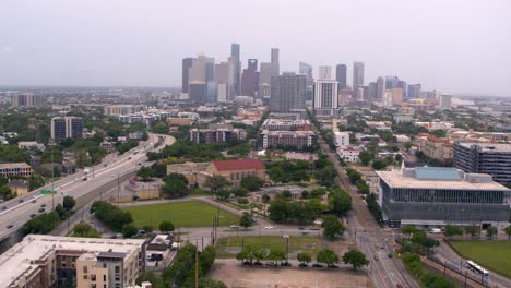 Drone-shot-moving-away-from-Downtown-Houston,-Texas-and-59-South-freeway