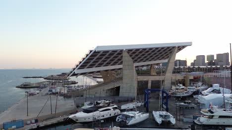 Aerial-drone-shot-of-the-Port-of-the-Forum-in-Barcelona-at-sunset