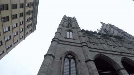 Sharp-angle-and-pan-of-Notre-Dame-Basilica-of-Montreal-on-a-cloudy-day