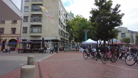 Malmo-Center---People-Walking-At-Triangeln-With-Parked-Bicycles-In-Malmo,-Sweden