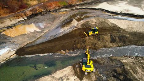 Aerial-shot-of-Bulldozer-and-excavate-working-on-a-river-diversion-in-a-land-development