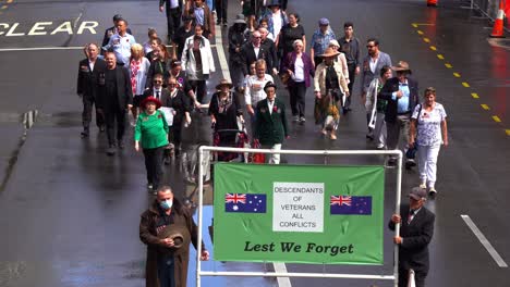 Descendants-of-veterans-from-all-conflicts-participate-in-the-Anzac-Day-parade-tradition,-walking-down-Adelaide-Street-in-Brisbane-City,-Queensland,-Australia