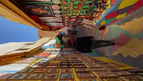 Vertical,-Tourist-Strolling-Colorful-Alley-Shops-in-Fez,-Morocco