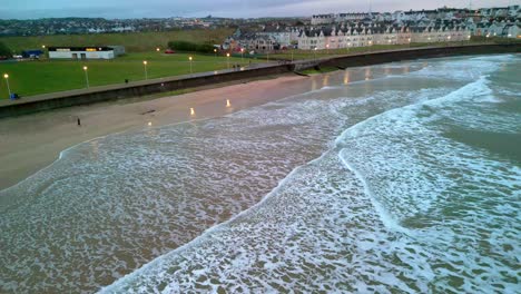 Wide-static-aerial-shot-of-Portrush-West-Strand-beach,-Northern-Ireland