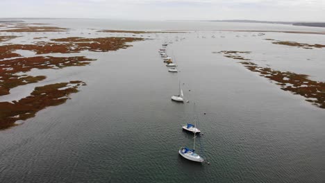 Aerial-Flying-Over-Moored-Sailing-Boats-In-Milford-On-Sea-Near-Hurst-Point