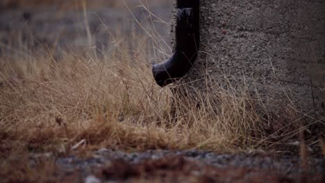 Water-Dripping-From-Downspout-Into-Dry-Grass-At-Farm