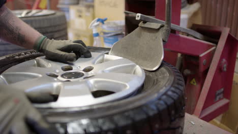 Mechanical-bead-breaker-used-to-separate-tyre-from-rim,-close-up