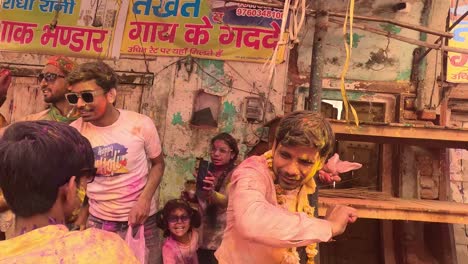 POV-SHOT-Many-men-are-having-fun-and-standing-on-the-side-and-throwing-colors-I-am-walking-towards-the-temple-where-many-different-photographers-are-also-seen