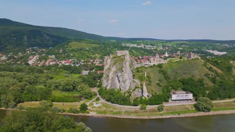 Drone-aerial-view-of-Devin-castle-near-Dabube-and-Morava-rivers-in-Bratislava,-Slovakia-on-sunny-day