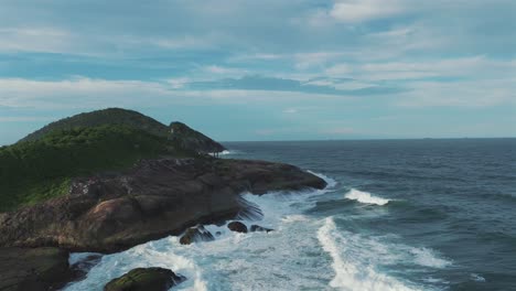 Beauty-of-the-Atlantic-Ocean-as-waves-gracefully-collide-with-rocky-cliffs-along-the-coast-of-São-Francisco-do-Sul,-Brazil