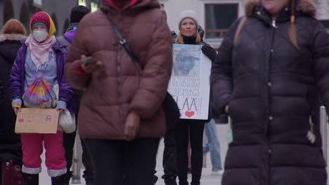 People-protesting-animal-cruelty-stand-quietly-on-busy-city-street