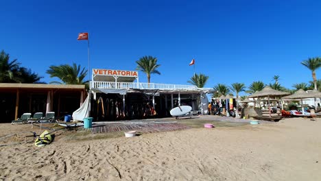 A-beach-with-a-white-building-with-the-word-Vetrathoria-on-it