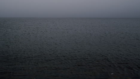 Surface-of-water-on-grey-misty-day