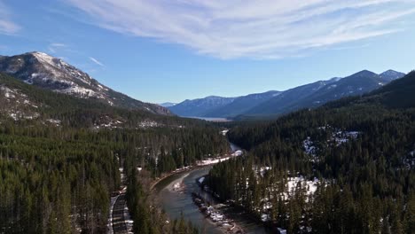 Scenic-view-of-river,-forest,-and-mountain-range-in-background-with-snow-in-Cle-Elum-on-a-peaceful-day-in-Washington-State