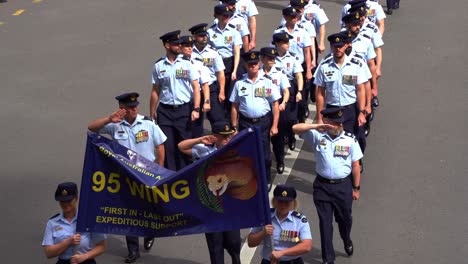 Disciplined-Royal-Australian-Air-Force-service-people-from-95-Wing,-uniformly-marching-down-the-street,-participating-in-Anzac-Day-parade,-paying-respect-to-those-who-served,-close-up-shot