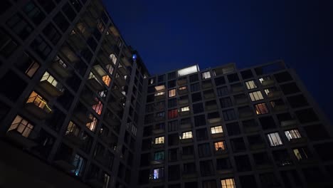 Modern-evening-apartment-with-illuminated-windows-pov-walk-to-overlay