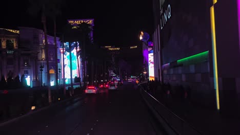Nachts-Auf-Dem-Las-Vegas-Strip-Fahren,-Verkehr-Und-Glänzende-Gebäude,-Hotels-Und-Casinos-Aus-Der-Perspektive