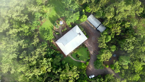 Drone-Aéreo-De-Niebla-Nubosa-A-Través-De-Fincas-Rurales-En-El-Bosque,-Girando-De-Arriba-Hacia-Abajo